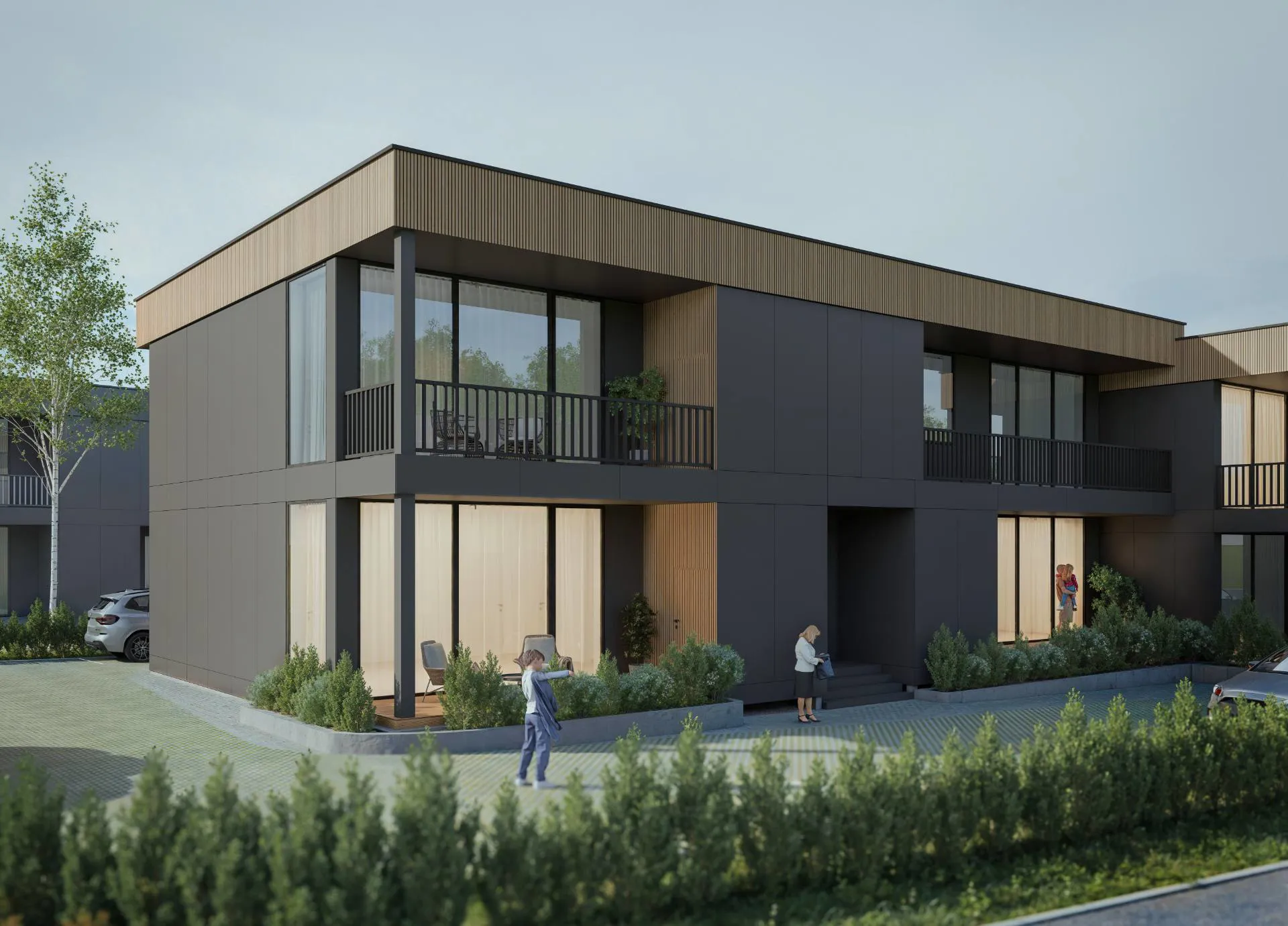 MK ARCH projektētā daudzdzīvokļu ēka Salaspilī vakara gaismā — koka apdares un balkonu detaļas